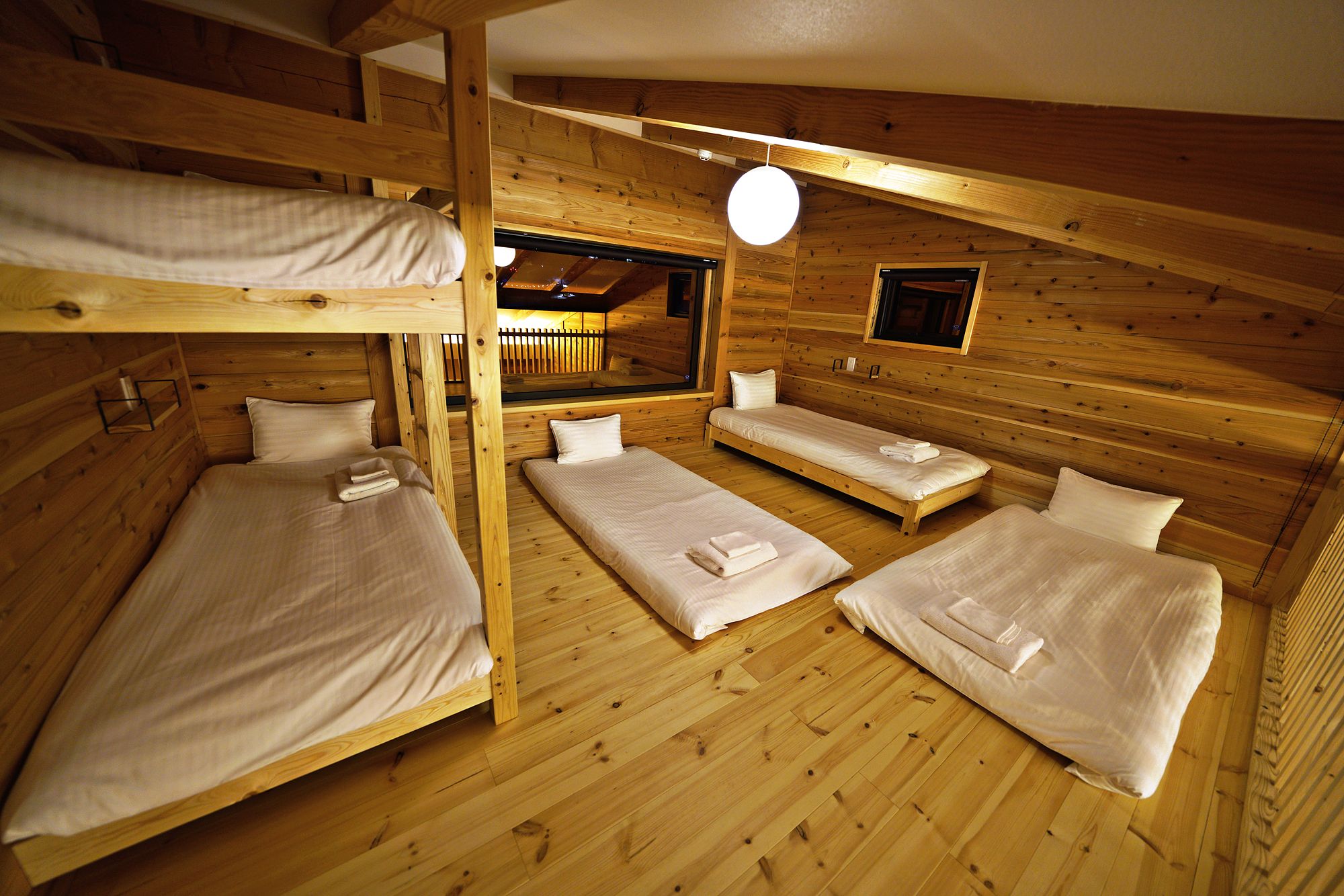 The loft with three single beds (two as a timber bunk) and two futons on the floor
