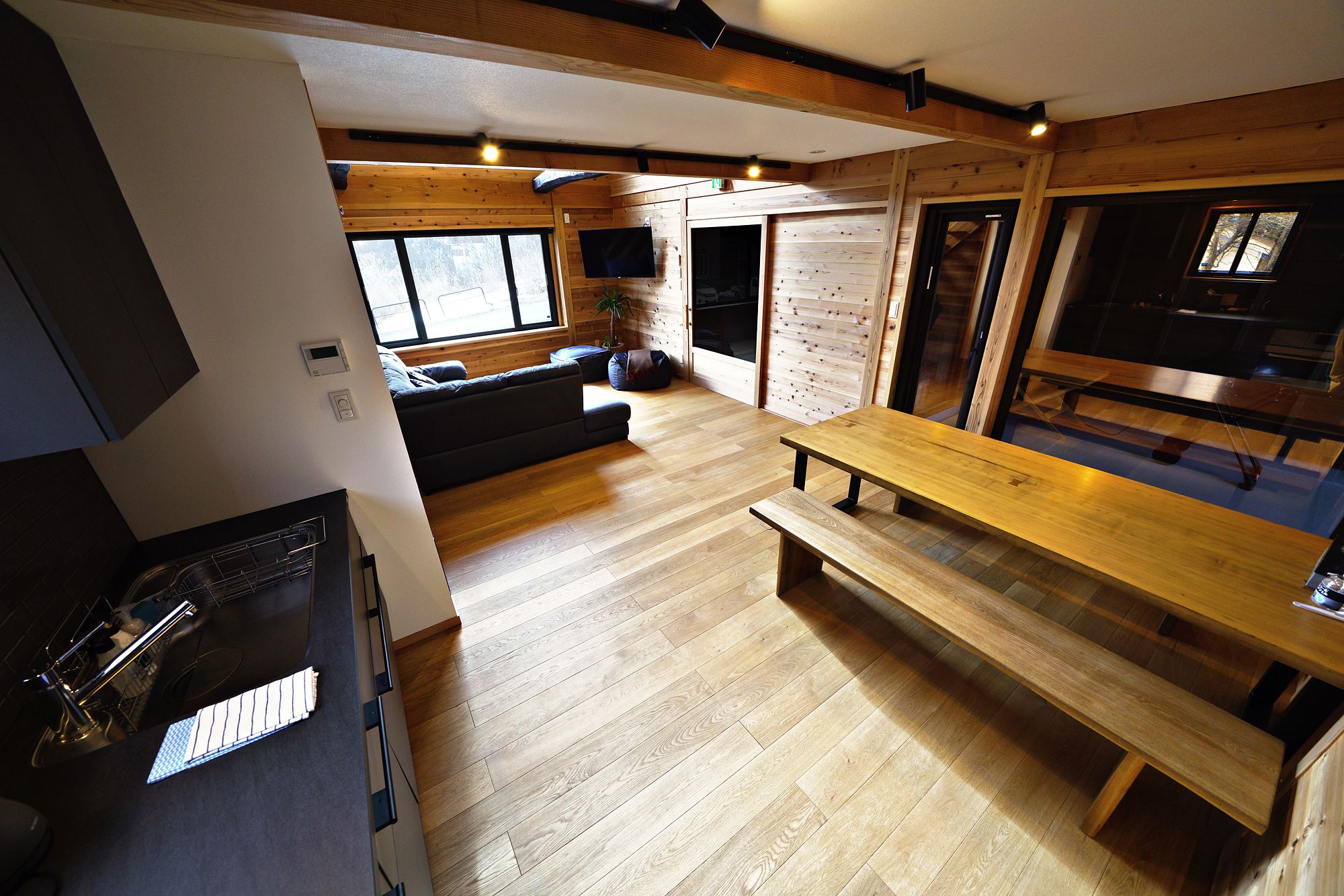 Kitchen, long timber dining table and living area