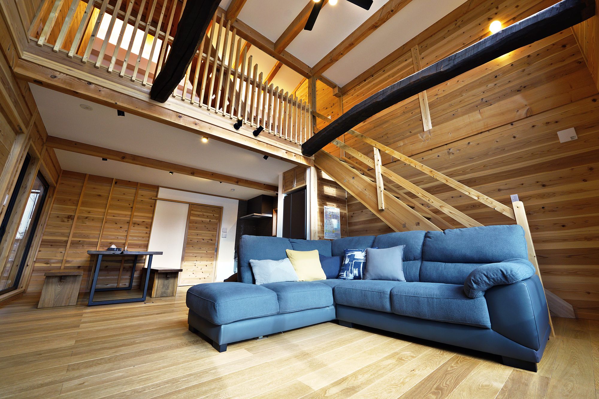 Living room and timber staircase up to the loft