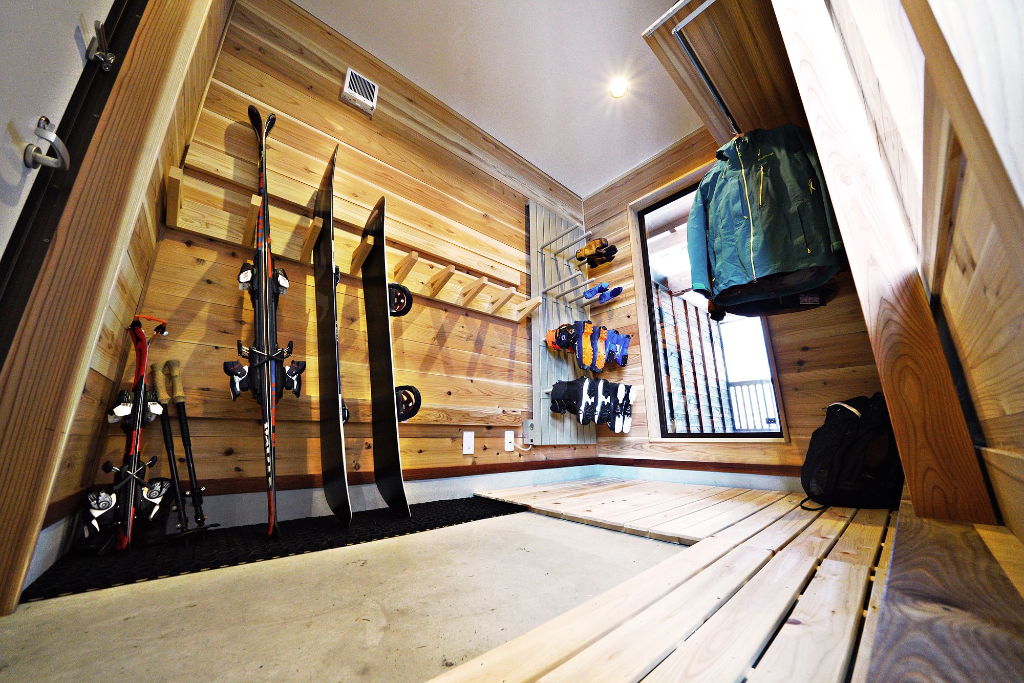 Gear room with ski racks, boot storage and hooks