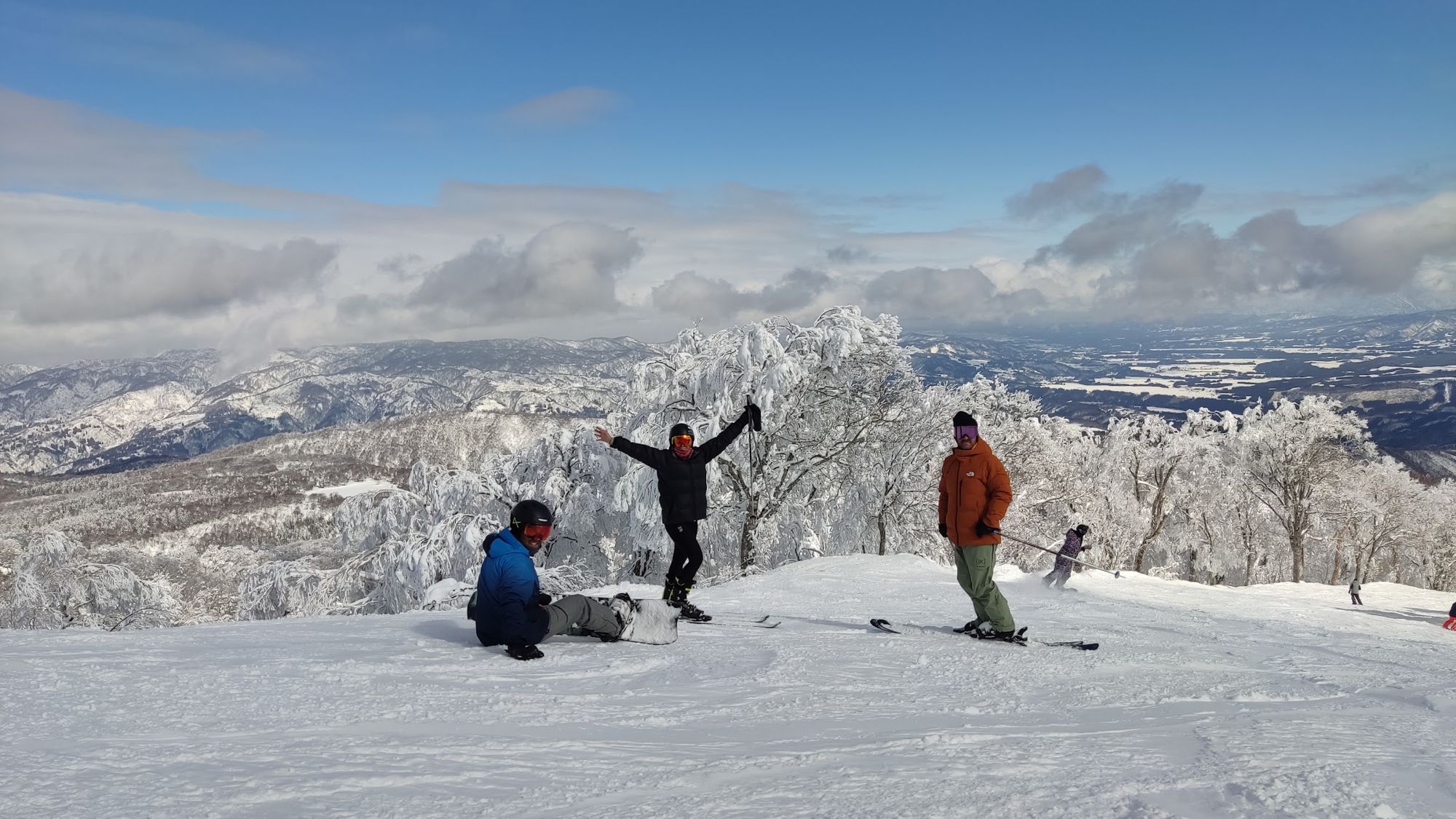 晴れた日に山頂で喜ぶ仲間たち